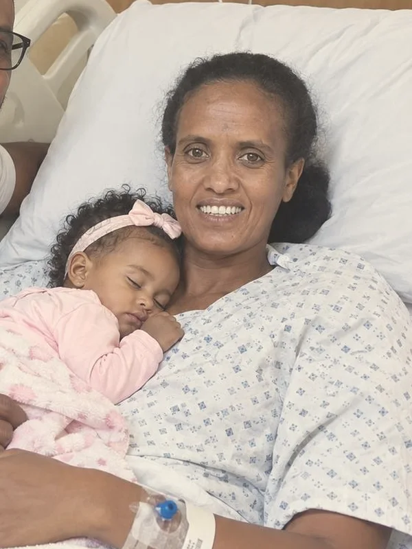 Tirsit in her hospital bed, smiling